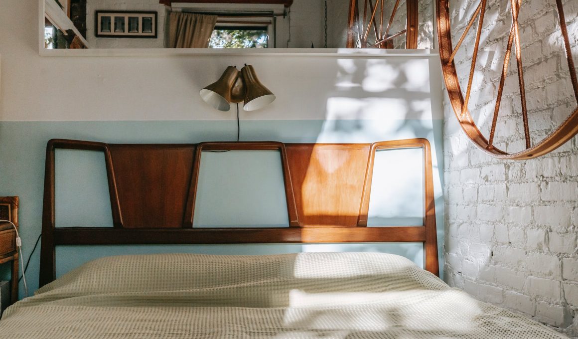 cozy bed in light brick bedroom