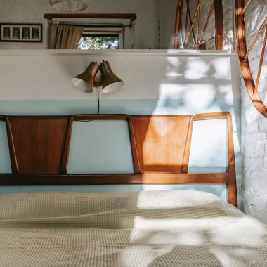 cozy bed in light brick bedroom