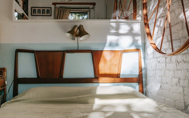 cozy bed in light brick bedroom