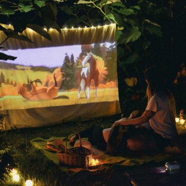 a couple watching a movie at a picnic date