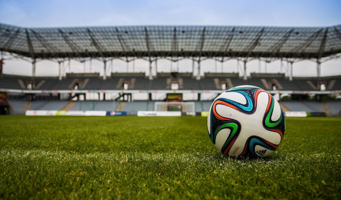 soccer ball on grass field during daytime