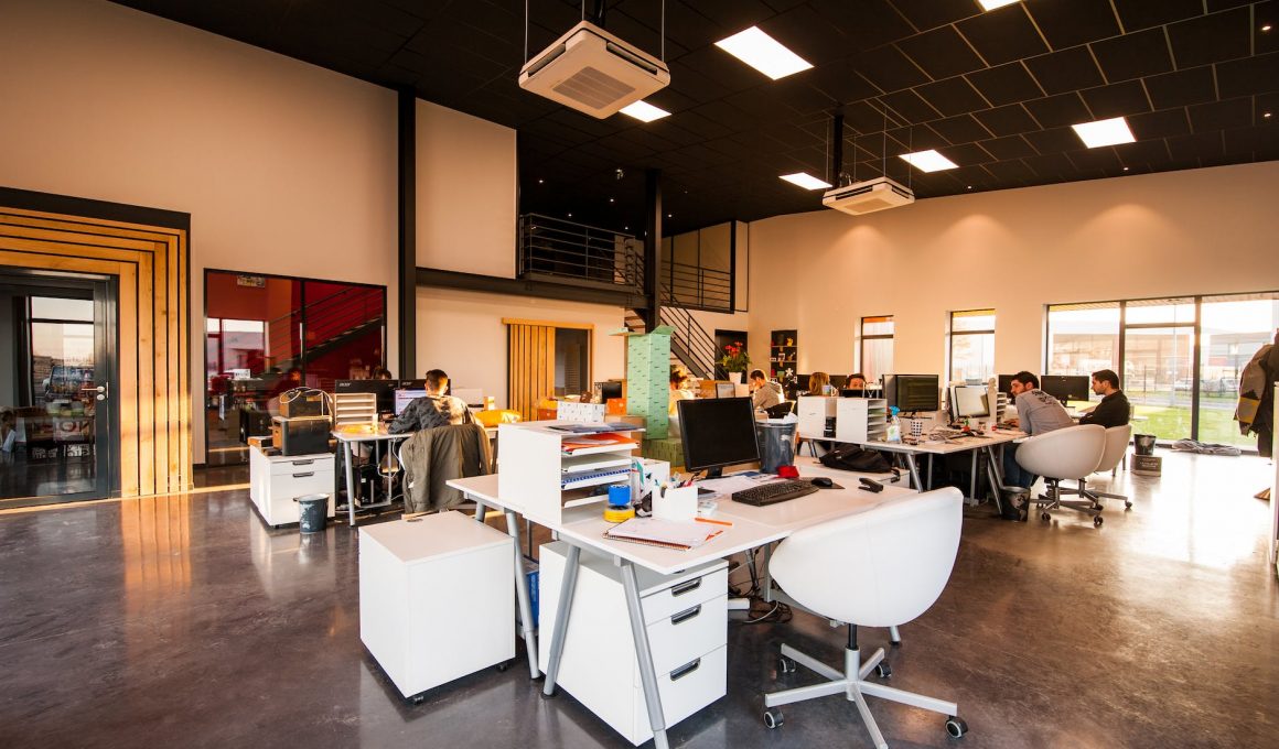 people sitting on chairs beside their desks in an office
