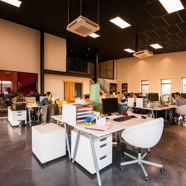 people sitting on chairs beside their desks in an office